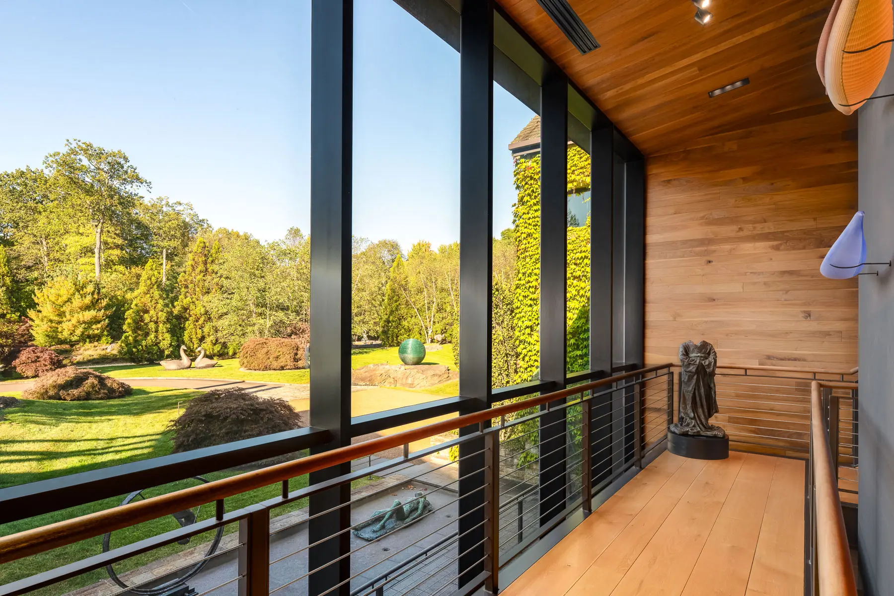 Glass-walled walkway overlooking the lawn at 114 John Street